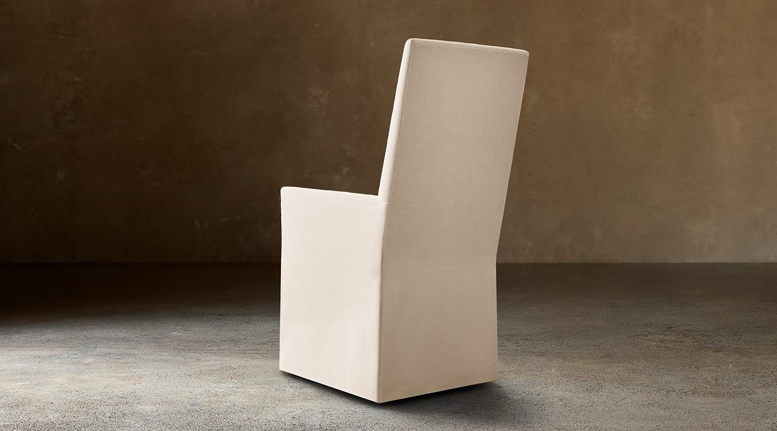 Alexandria Fabric Dining Armchair With Nailheads – rear three-quarter view in natural-toned upholstery