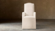 Alexandria Camelback Fabric Dining Armchair With Nailheads – front view in natural-toned upholstery