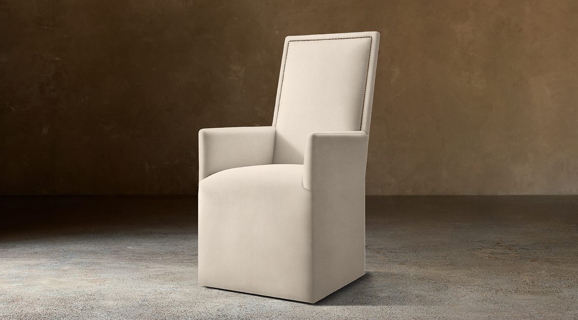 Alexandria Fabric Dining Armchair With Nailheads – three-quarter view in natural-toned upholstery