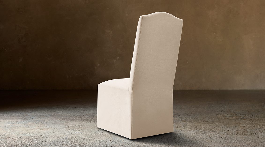 Alexandria Camelback Fabric Dining Side Chair With Nailheads – rear three-quarter view in natural-toned upholstery