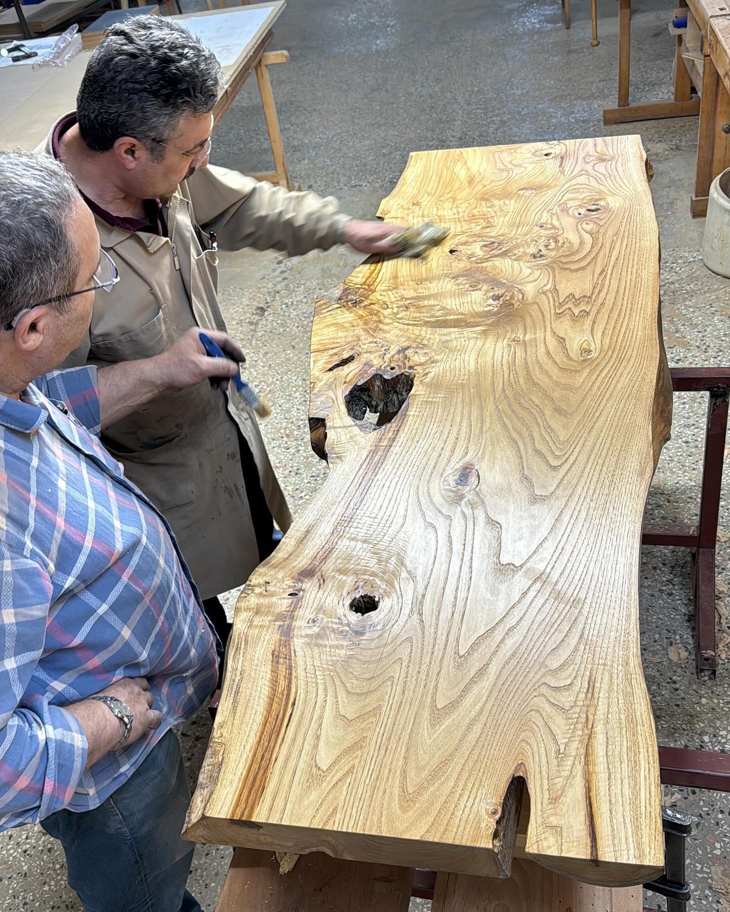 Craftsman finishing a live-edge slab at our partner workshop, Bulut Dekorasyon
